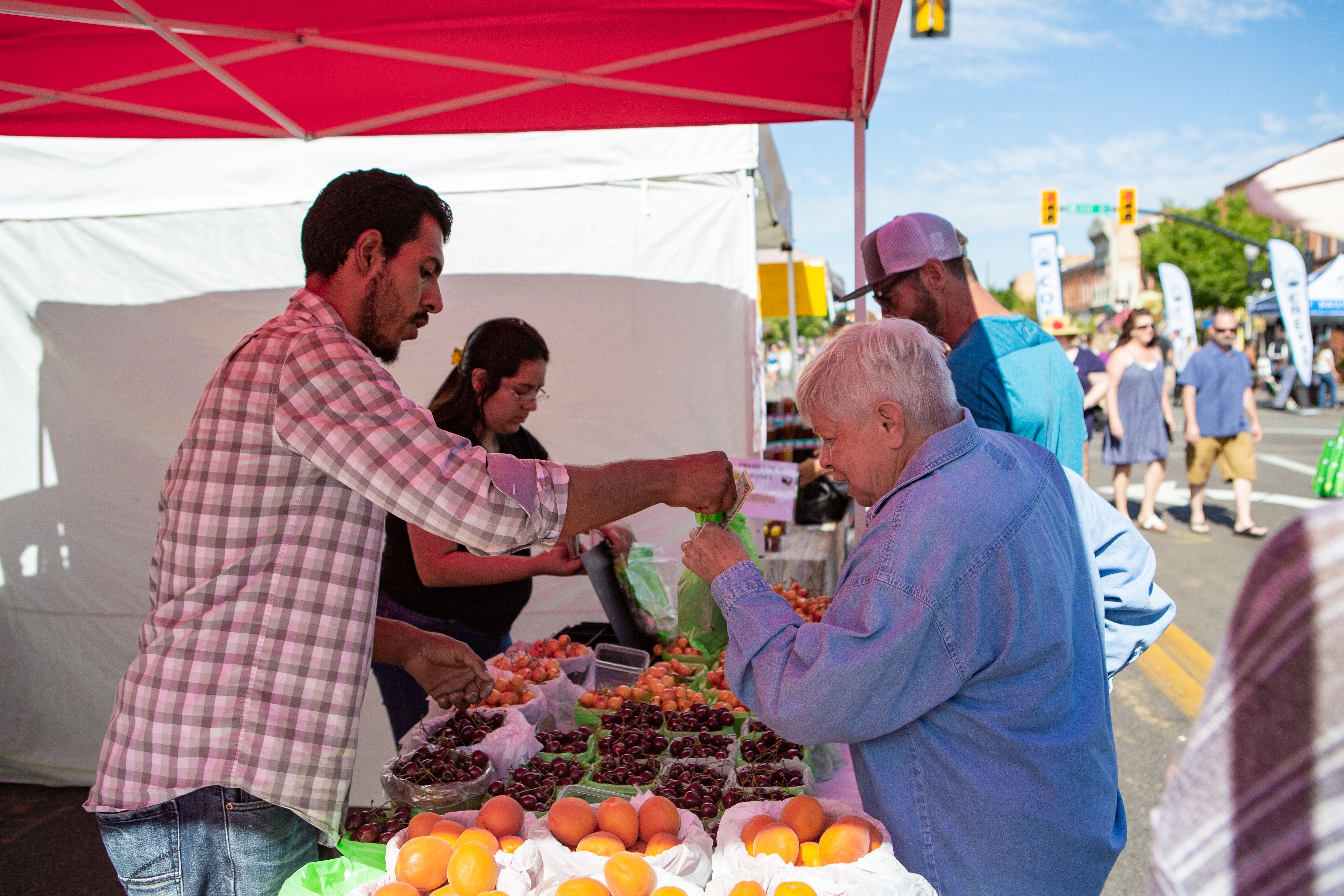 Woman buying cherries at Ogden Farmer's Market